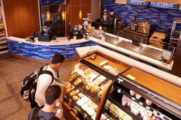 Students browsing food options inside Seidman Cafe